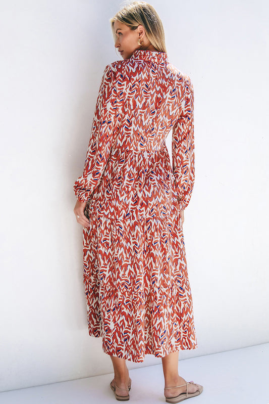 Woman wearing a long, patterned maxi dress against a white background